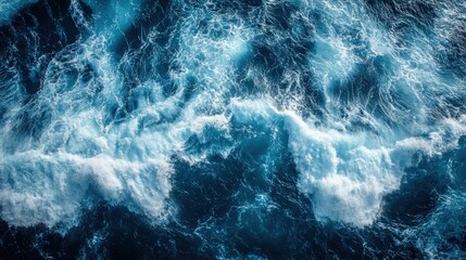 Aerial perspective of the Pacific Ocean displaying turbulent waves, showcasing the dynamic movement and powerful energy of the water