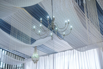 Ceiling decoration with tulle and eclectic chandeliers