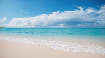 Fototapeta premium Royal blue sea brushes against a sandy shore beneath a tranquil cloud-filled sky 
