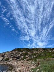 Rocky coast with clouds and reefs Porto Ferro. Sassari. Sardinia. Italy. 