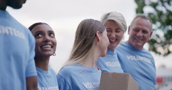 Happy, people and volunteer walking, talking and bond after social responsibility, charity or city community service. Solidarity, NGO group kindness and face of society chat about nonprofit outreach