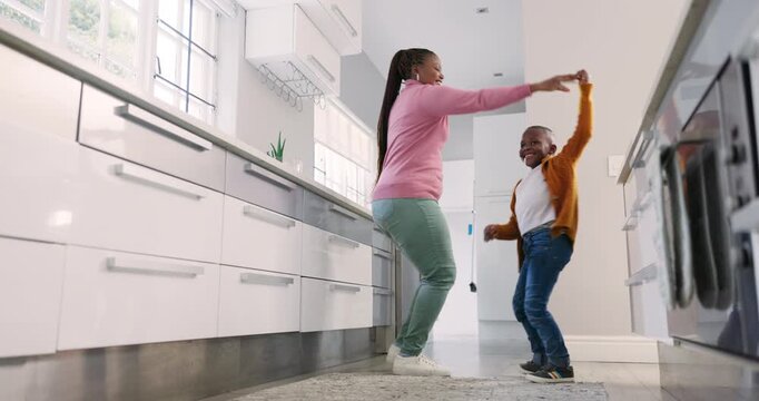 Happy mother, kitchen and black family child dance, smile and enjoy fun time together, music and excited energy. Spin, happiness and home mom, mama and African woman teaching, twirl and support kid