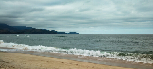 Sea river water beach cove ocean wave sand land stone rock mountain hill forest tree flowers bushes vegetation blue sky cloudy cloud horizon landscape island vacation surfing sport life nature