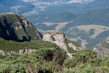 Photo of iconic holed stone in the middle of São Joaquim National Park, in Urubici, state of Santa Catarina, Brazil.