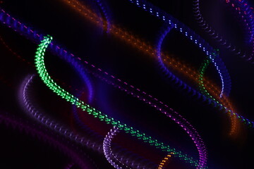 Una toma de cerca de varias luces de colores en movimiento en la oscuridad. Movimiento de cámara  © Elika R