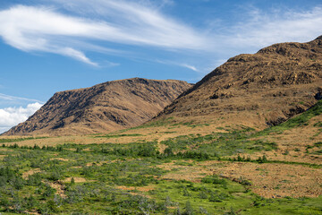 A supercontinent called Pangea, the Tablelands are a unique ultramafic geological rock formation - peridotite in Newfoundland. A barren, orange landscape of the Earth's inner bare rock, the mantle. 