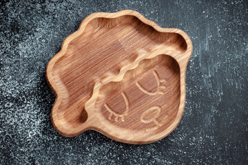 A plate for children in the shape of a lamb is made of wood for serving snacks, fruits, nuts, cheeses, meat and original serving of main dishes. Accessories for a modern kitchen.
