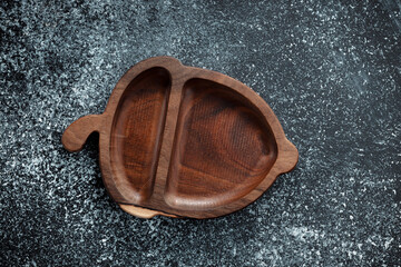 The children's plate in the shape of an acorn is made of wood for serving snacks, fruits, nuts, cheeses, meat and original serving of main dishes. Accessories for a modern kitchen.