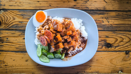 Crispy pork rice on a blue plate on the dining table