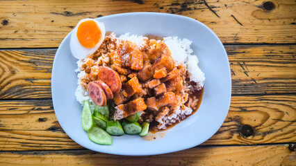 Crispy pork rice on a blue plate on the dining table