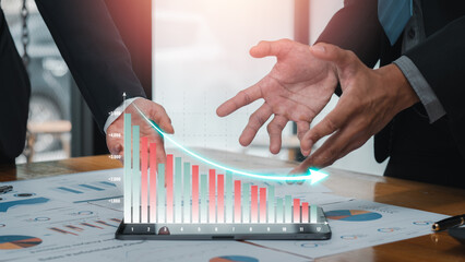 Business professionals analyzing cost reduction strategies with graphs and charts, showcasing financial planning and efficiency.