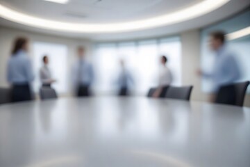 Blurred image of a conference room with people and table.