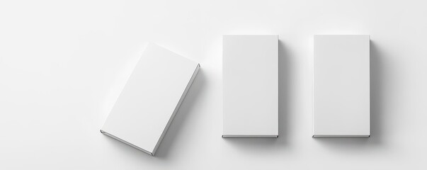 Minimalistic top view of three white rectangular boxes on a white background. Ideal for design presentations, branding, and packaging concepts.