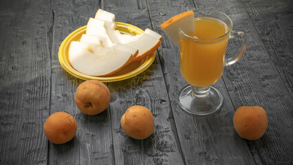 Fresh Summer Snack: Sliced Melon and Apricots with Refreshing Beverage on Rustic Wooden Table