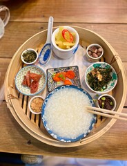 A colorful assortment of Chinese dishes featuring rice with shrimp, eggs, and various vibrant vegetables. Chinese breakfast food.
