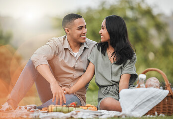 Happy, nature and couple on picnic for date with romance on vacation, getaway or weekend trip. Love, basket and young man and woman with connection, bonding and marriage activity in outdoor park.