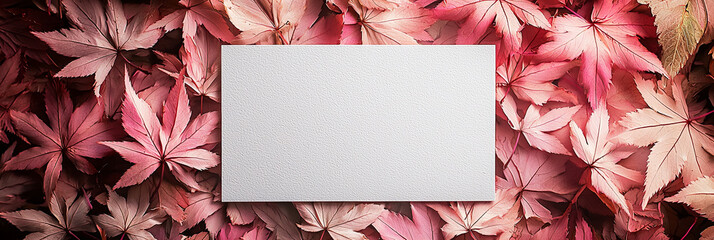 Obraz premium A white card with a pink maple leaves background, generative AI