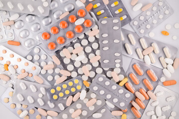 background of multi-colored tablets in blister packs
