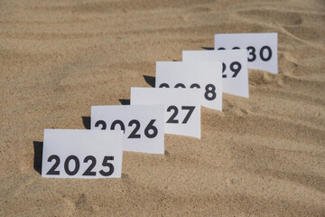 Paper cards with numbers of years from 2024 to 2030 in a row. New year start concept. Resolution...