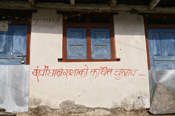 Nepalese house in the Himalayas with a Hindu inscription