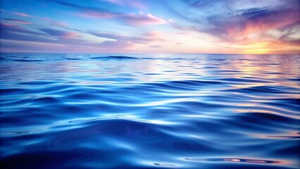 Obraz premium Serene Sunset Over Calm Ocean Waters - A breathtaking sunset casts warm hues over the tranquil ocean, reflecting on the rippling waves. The image evokes feelings of peace, tranquility, and the beauty 