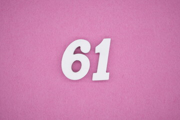 The numbers are made of white painted wood. Laying on the floor was pink paper.