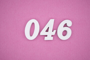 The numbers are made of white painted wood. Laying on the floor was pink paper.