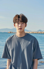 Fototapeta premium Handsome Asian guy by the sea