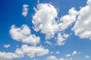 White passenger airplane flying in the sky amazing clouds in the background