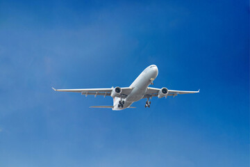White passenger airplane flying in the sky amazing clouds in the background
