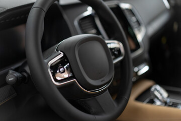 Car interior with steering wheel and control elements.