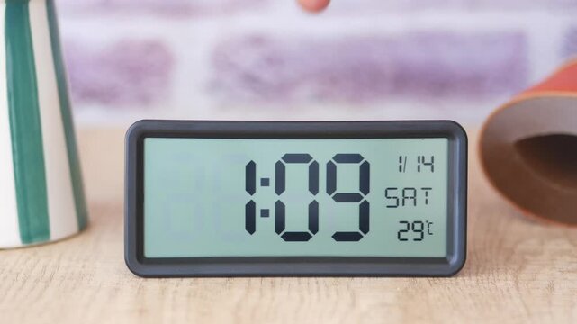 Start your day right by placing a digital alarm clock on a table to wake up in the morning