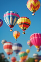 Naklejka premium A colorful hot air balloon festival with miniature balloons floating in the sky, enhanced by the tilt-shift effect. 