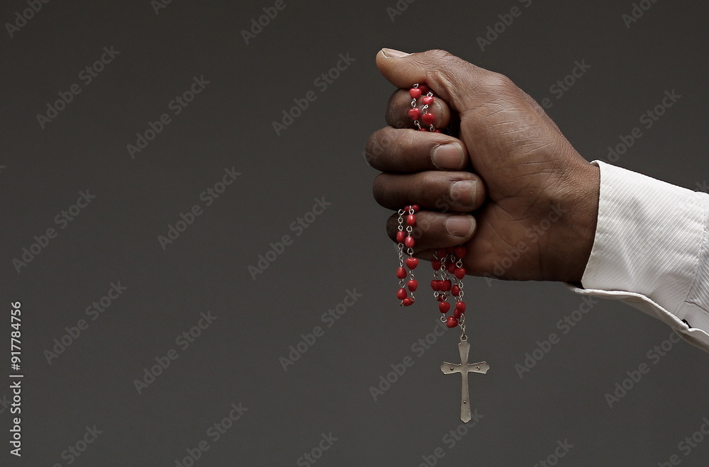 Wall mural praying to god with hands together on black background with people stock image stock photo	