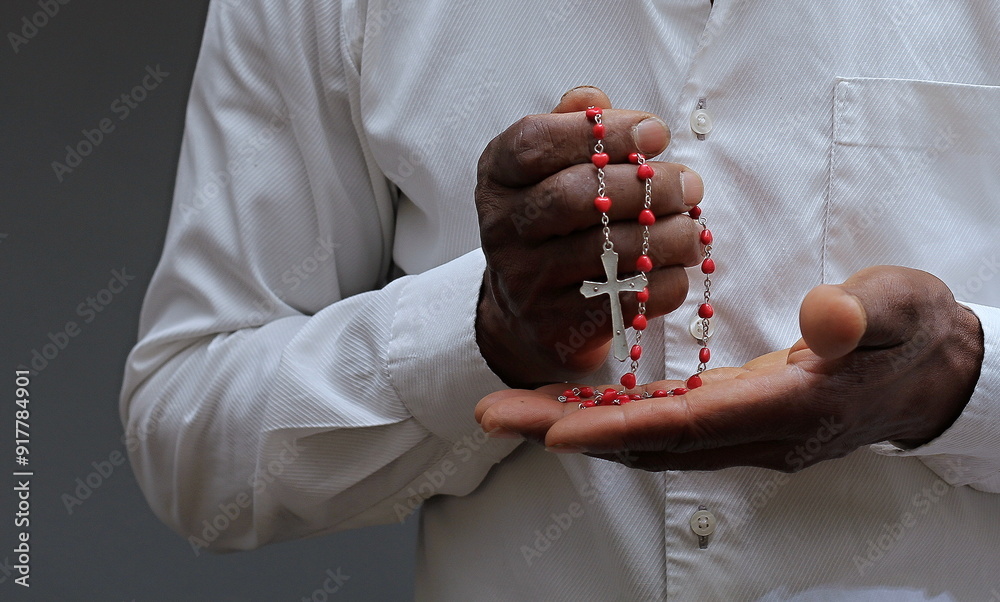 Wall mural praying to god with hands together on black background with people stock image stock photo	