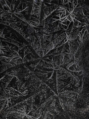 Chrystal clear frosty textured natural ice block in cold shades of grey tones, isolated on black background.