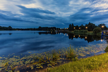 Tranquil reflections on a lake at dusk with calm water and bright colors