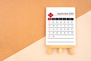 2024 September calendar page on brown background.