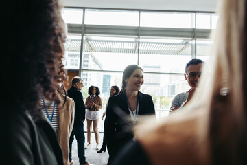 Businesswoman engaging in lively conference discussion highlighting collaboration and networking