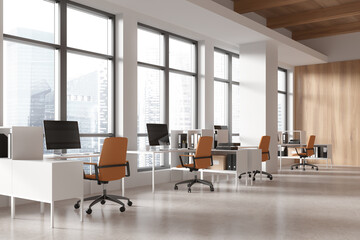 Workspace interior with armchairs and desks, pc monitors and shelf near window