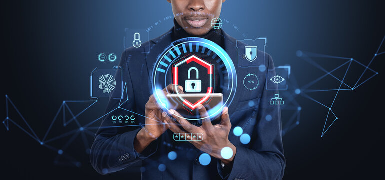 African businessman with tablet, cybersecurity hologram and data protection