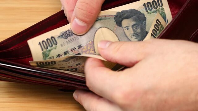 Japanese Yen. Counting money in a wallet, small amount of cash, Economic crisis, expense analysis, household budget. Japan money