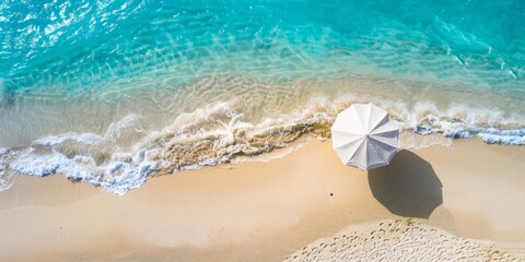 Fototapeta premium Aerial View of a Beach Umbrella on a Sandy Shore