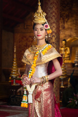 The beautiful performance shows Asian pretty women wearing traditional dress costumes in the Ramakien story of ancient in the past of Thai literature at famous temple in Chiang Mai Thailand.