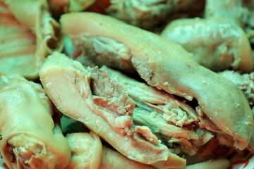 A close-up of boiled pig trotters, showcasing the texture and detail of traditional Asian cuisine, is ideal for food-related content and culinary presentations.