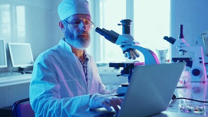 Chemist Analyzing Samples Using Microscope in Neon Purple Laboratory Setting