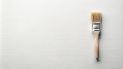 A solitary white-bristled paintbrush rests on a clean, bright white background, waiting for the artist's stroke, against a pristine and minimalist creative canvas.