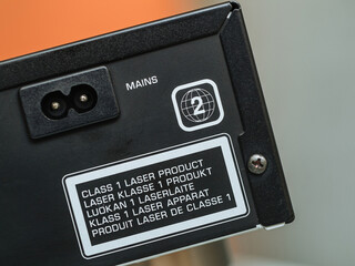 A Class 1 Laser Product phrase displayed in multiple languages on a high-end DVD Blu-ray player,...