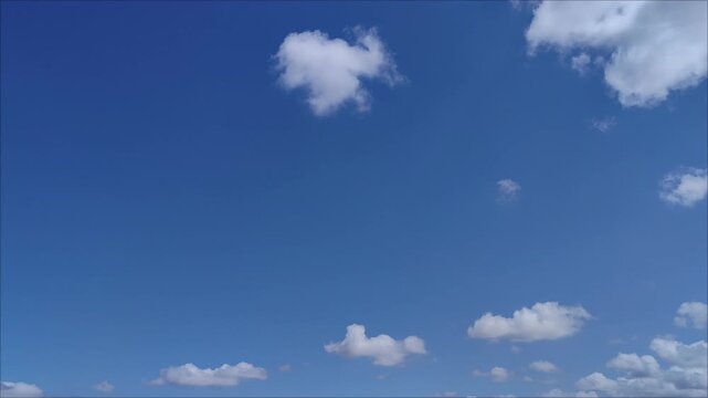 Radiant blue sky landscape with small clouds moving in the morning