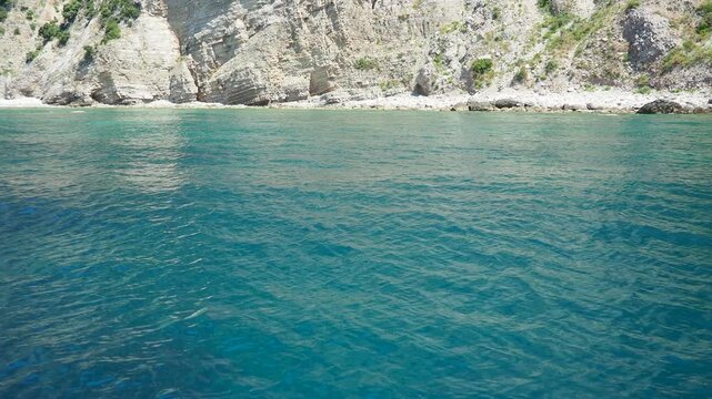 Rt Dubovica Rocks near Buljarica and Svetac Rock, Montenegro. Stones, inaccessible rocks. Flysch marine lithological layers. Adriatic Mediterranean sea blue water. Nature park Katici. District Budva